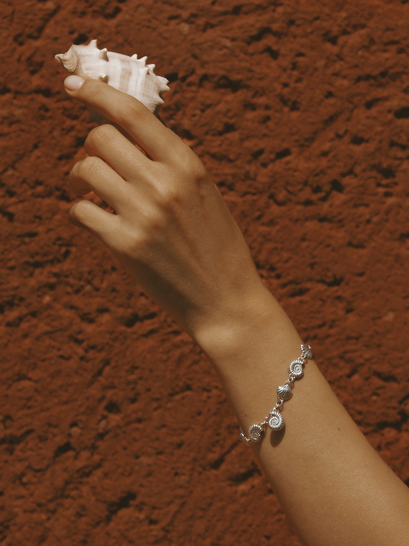 The Power of Love Bracelet in sterling silver by Pola Jewellery—shell and spiral design symbolizing love, protection, and graceful balance.