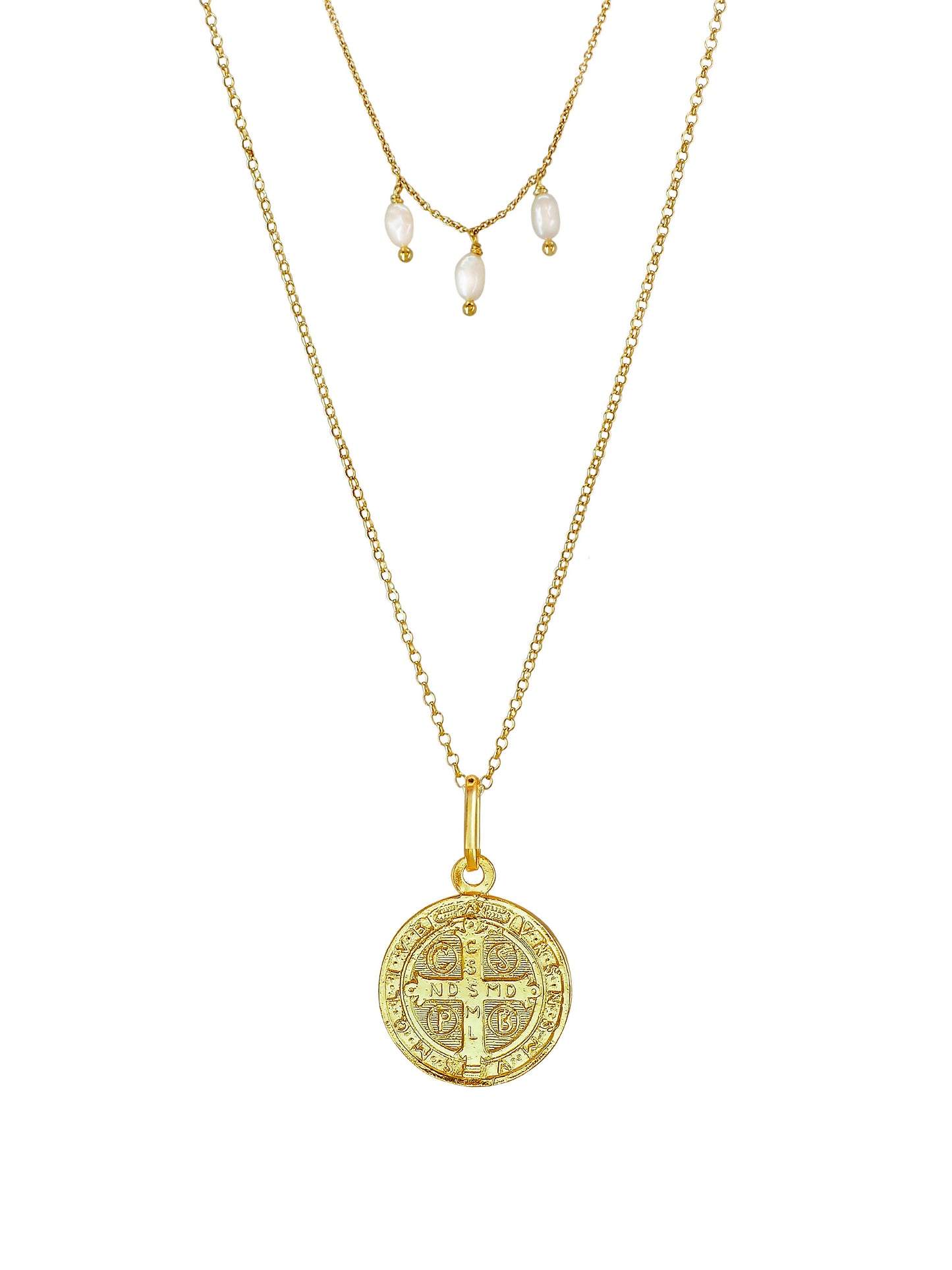 Close-up of St. Benedict medallion with engraved cross and Latin text on gold-plated sterling-silver necklace with pearls.
