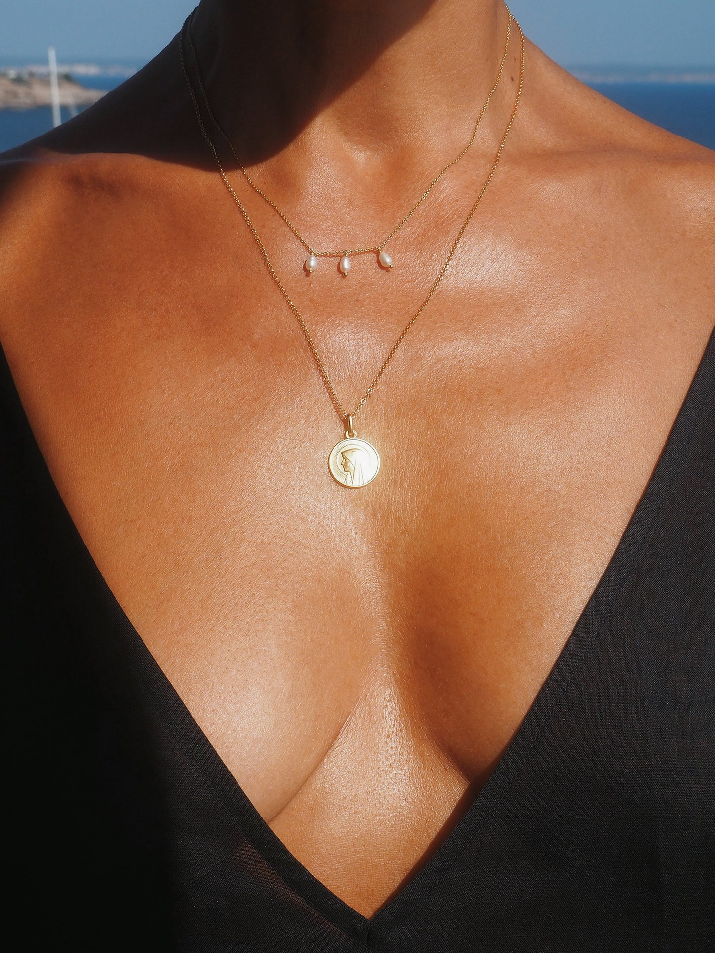 Double-chain Lourdes necklace with antique pendant and pearls in gold-plated silver. A romantic, healing talisman handcrafted in Mallorca.
