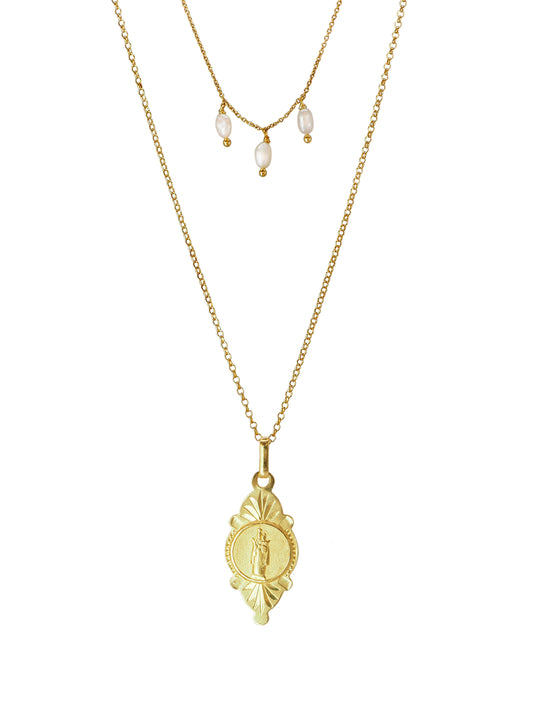 Double-chain necklace featuring an antique pendant engraved with an image of Our Lady of Good Health. Three dangling Baroque Pearls complete this mighty set perfectly. Gold plated Silver.