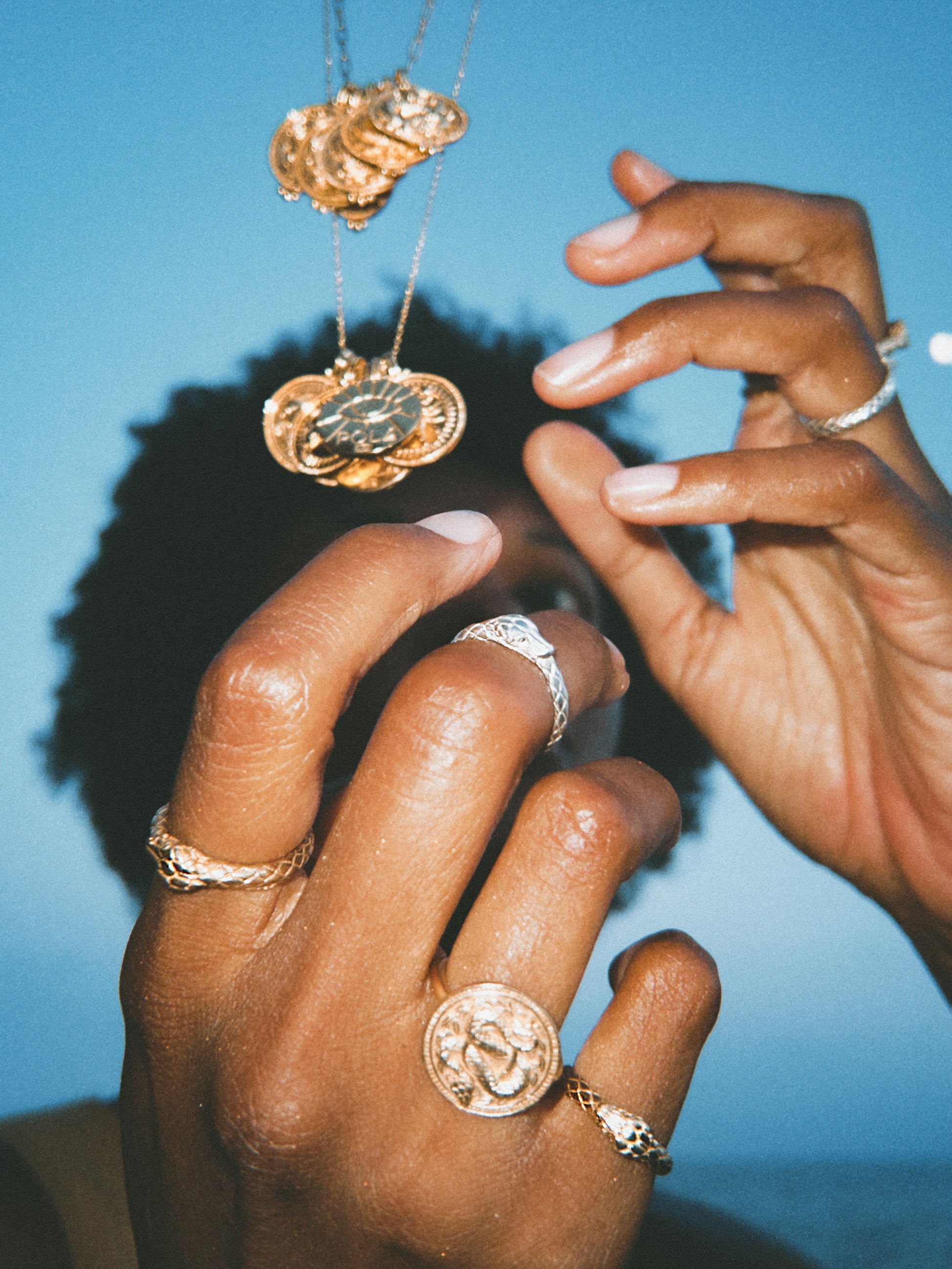 Woman's hand stacked with Ouroboros Rings in solid white and yellow gold by Pola Jewellery — eternal love snake ring set, handcrafted in Barcelona designed in Mallorca.
