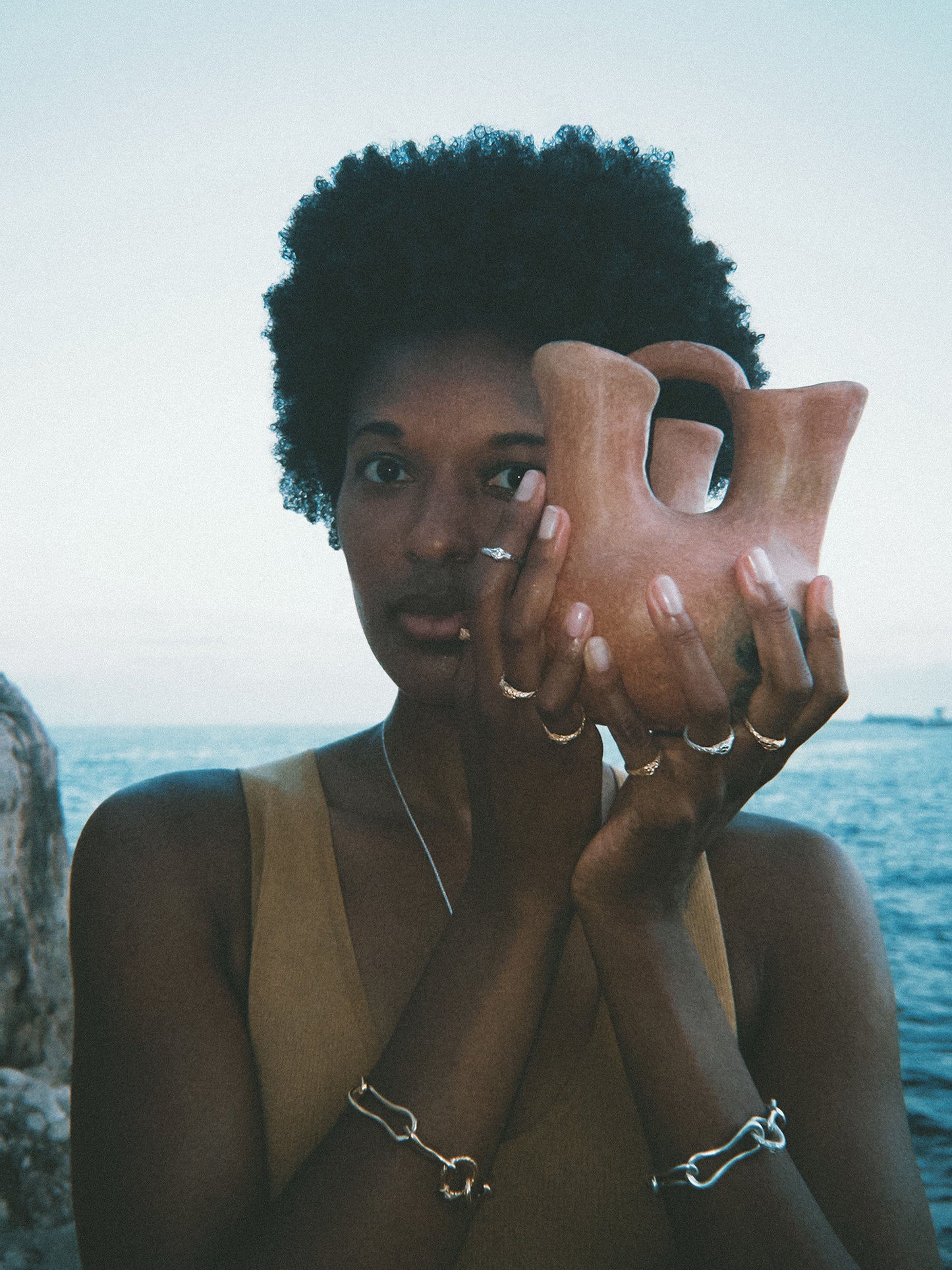 Multiple Ouroboros snake rings in solid white and yellow gold stacked on hands by Pola Jewellery — gender-neutral eternal love rings, made to order, designed in Mallorca.