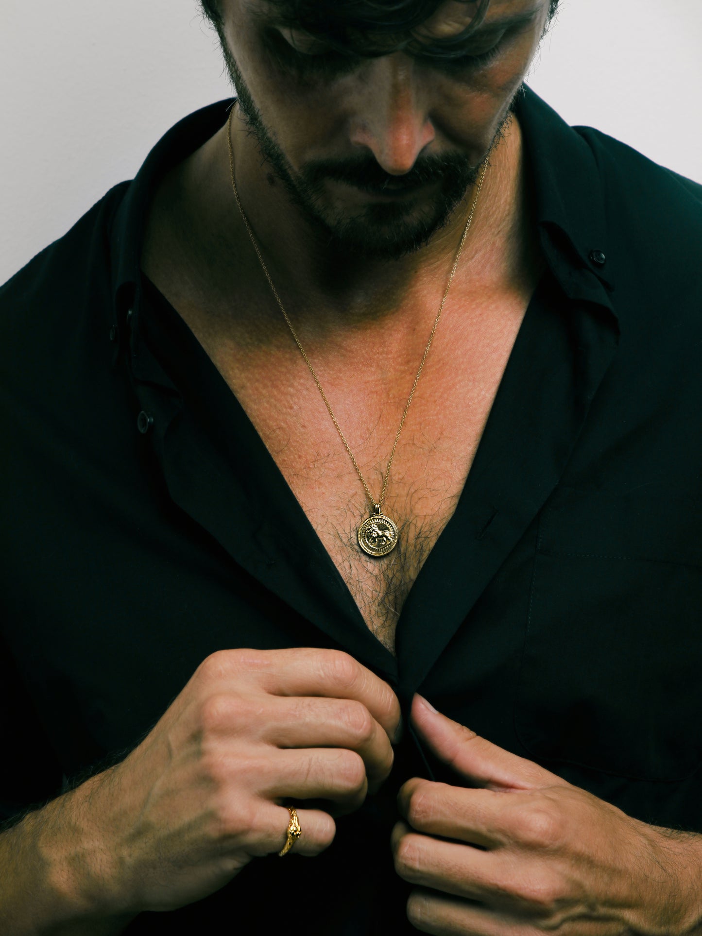 Male model wearing Pola Jewellery’s Leo Zodiac Necklace in gold vermeil — a bold, radiant piece symbolizing leadership and creative fire.