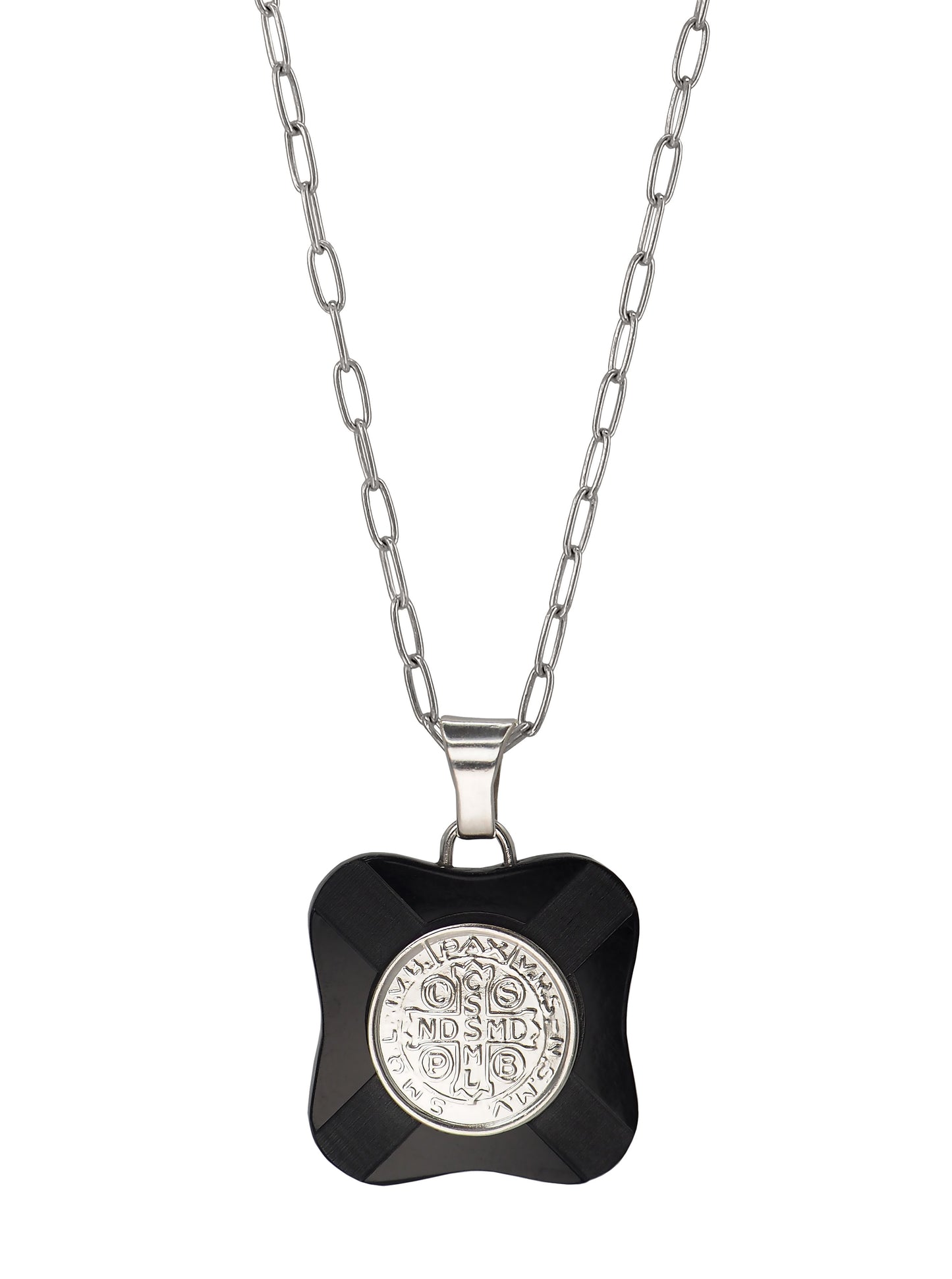 Close-up of vintage St. Benedict pendant with Latin inscription in silver and black Bakelite.